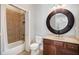 Bathroom with a large round mirror, a built-in vanity, and a shower/tub combination at 2105 Monhegan Se Way # 13, Smyrna, GA 30080