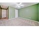Bright bedroom with green walls, beige carpet, and ceiling fan at 45 Eagle Glen Ne Dr, Cartersville, GA 30121