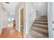 Bright entryway with hardwood floors, stairs, and a half-bath at 45 Eagle Glen Ne Dr, Cartersville, GA 30121