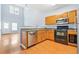 Modern kitchen with light wood cabinets, stainless steel appliances, and hardwood floors at 45 Eagle Glen Ne Dr, Cartersville, GA 30121