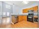 Modern kitchen with light wood cabinets, stainless steel appliances, and hardwood floors at 45 Eagle Glen Ne Dr, Cartersville, GA 30121