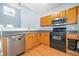Modern kitchen with light wood cabinets, stainless steel appliances, and hardwood floors at 45 Eagle Glen Ne Dr, Cartersville, GA 30121