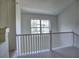 Upper landing with carpeting, white railing, and a window overlooking the living area at 221 Semel Nw Cir # 273, Atlanta, GA 30309