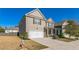 Two-story house with gray siding, a white garage door, and a landscaped yard at 1240 Grove Pkwy, Jonesboro, GA 30236