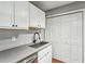 White kitchen cabinets, gray counters, and stainless steel sink at 2838 Vinings Central Se Dr # 148, Atlanta, GA 30339