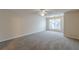 Spacious bedroom with grey carpet, ceiling fan, and large window at 3757 Harvest Dr, Decatur, GA 30034