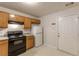Kitchen features oak cabinets, black appliances, and exterior access at 3757 Harvest Dr, Decatur, GA 30034