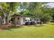 Lakefront cottage exterior showcasing a green roof and lawn at 24 Allatoona Landing Lot 19 Se Rd, Cartersville, GA 30121