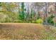 Fenced backyard with a grassy area and trees at 1273 Anchor Sw Ter, Atlanta, GA 30311
