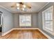 Living room with hardwood floors, ceiling fan, and large windows at 111 N Lee St, Stockbridge, GA 30281