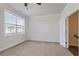 Well-lit bedroom with ceiling fan, carpet and access to stairs at 3879 Glenview Club Ln, Duluth, GA 30097