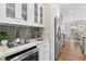 Kitchen wet bar with wine fridge and gray tile backsplash at 1214 Bernadette Ne Ln, Atlanta, GA 30329