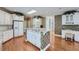 White kitchen with island, cooktop and hardwood floors at 2023 Ector Nw Ct, Kennesaw, GA 30152