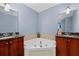 Bathroom with corner soaking tub and double vanity at 285 Centennial Olympic Park Nw Dr # 401, Atlanta, GA 30313
