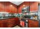 Well-equipped kitchen featuring dark wood cabinets and granite countertops at 285 Centennial Olympic Park Nw Dr # 401, Atlanta, GA 30313