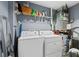 Convenient laundry room with washer, dryer, and shelving at 285 Centennial Olympic Park Nw Dr # 401, Atlanta, GA 30313