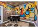 Modern wet bar with artistic wall mural and bar stools at 285 Centennial Olympic Park Nw Dr # 401, Atlanta, GA 30313