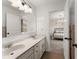 Well-lit bathroom with double sinks and a view into a bedroom at 3045 Pleasant Valley Trl, Cumming, GA 30028