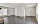 Spacious living room with dark gray vinyl plank flooring and an open floor plan at 5815 Feldwood Rd, Atlanta, GA 30349