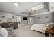 Main bedroom with sitting area, tray ceiling, and wine cooler at 6354 Old Wood Hollow Way, Buford, GA 30518