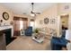 Living room with fireplace, floral couch, and ceiling fan at 98 Hill Side Way, Hiram, GA 30141