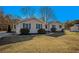 Tan house with blue door and shutters, and a spacious yard at 135 Country Squire Dr, Fayetteville, GA 30215