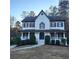 Two-story house with white siding, black shutters, and a blue front door at 1420 Midland Way, Lawrenceville, GA 30043