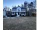 Two-story house with white siding, black shutters, and a blue front door at 1420 Midland Way, Lawrenceville, GA 30043