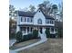 Charming two-story home with a blue front door, white siding, and a landscaped yard at 1420 Midland Way, Lawrenceville, GA 30043