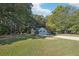 Ranch style home with a tree-lined street and large yard at 45 Park Place Dr, Covington, GA 30016