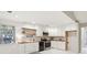 Renovated kitchen boasts white cabinets, a wood countertop, and floating shelves at 45 Park Place Dr, Covington, GA 30016