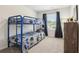 Fun bedroom with a blue bunk bed, window, and plenty of natural light at 318 Crimson Dr, Union City, GA 30291