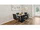 Modern dining area with glass table, black chairs, and hardwood floors at 318 Crimson Dr, Union City, GA 30291