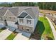 Two-story townhome with gray and beige siding, brick accents, and a two-car garage at 318 Crimson Dr, Union City, GA 30291