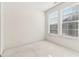 Bright bedroom with carpet, neutral walls, and two windows at 621 Broadview Ne Ter, Atlanta, GA 30324
