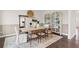 Modern dining room with a light wood table, neutral decor, and built-in shelving at 108 Aj Welch Jr Way, Mcdonough, GA 30252