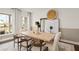 Modern dining room with a light wood table, neutral decor, and built-in shelving at 108 Aj Welch Jr Way, Mcdonough, GA 30252