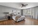 Main bedroom with hardwood floors, ceiling fan, and large window at 520 Salem Woods Se Dr, Marietta, GA 30067