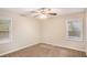 Bright bedroom with ceiling fan and neutral carpeting at 1883 Meadow Ln, Decatur, GA 30032