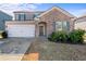 Two-story home with brick and siding exterior, two-car garage, and landscaped yard at 248 Hamilton Pointe Dr, Mcdonough, GA 30253