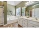 Elegant bathroom with double vanity and soaking tub at 4130 Ruby Forest Blvd, Suwanee, GA 30024