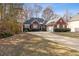 Brick ranch house with attached garage and landscaped yard at 4130 Ruby Forest Blvd, Suwanee, GA 30024