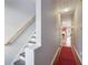 Bright entryway with red carpet runner and staircase leading upstairs at 786 Brookside Parc Ln, Avondale Estates, GA 30002