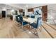 Modern dining room with a white table, blue chairs, and hardwood floors at 2751 Margaret Mitchell Nw Dr, Atlanta, GA 30327