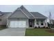 Newly constructed home with gray siding, brick accents, and a two-car garage at 756 Vireo Walk, Loganville, GA 30052