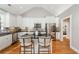 Modern white kitchen with stainless steel appliances, dark granite countertops, and an island at 238 Fowler St, Woodstock, GA 30189