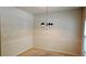 Simple dining area with chandelier and neutral walls at 420 Berckman Nw Dr, Lilburn, GA 30047