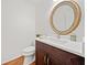 Modern powder room with dark vanity and round ornate mirror at 1237 Wynford Colony Sw, Marietta, GA 30064