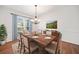 Formal dining room with hardwood floors, chandelier, and large windows at 1237 Wynford Colony Sw, Marietta, GA 30064