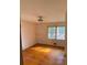 Simple bedroom with hardwood floors and a window at 3955 Demooney Rd, Atlanta, GA 30349